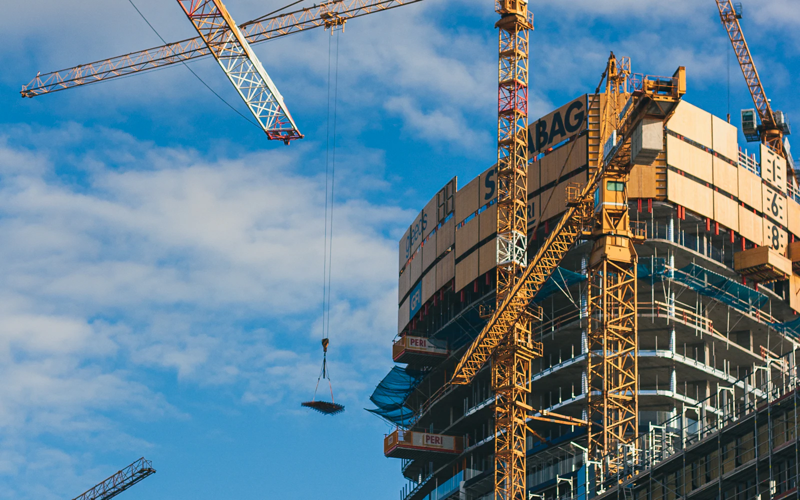 High-rise building under construction with a tower crane