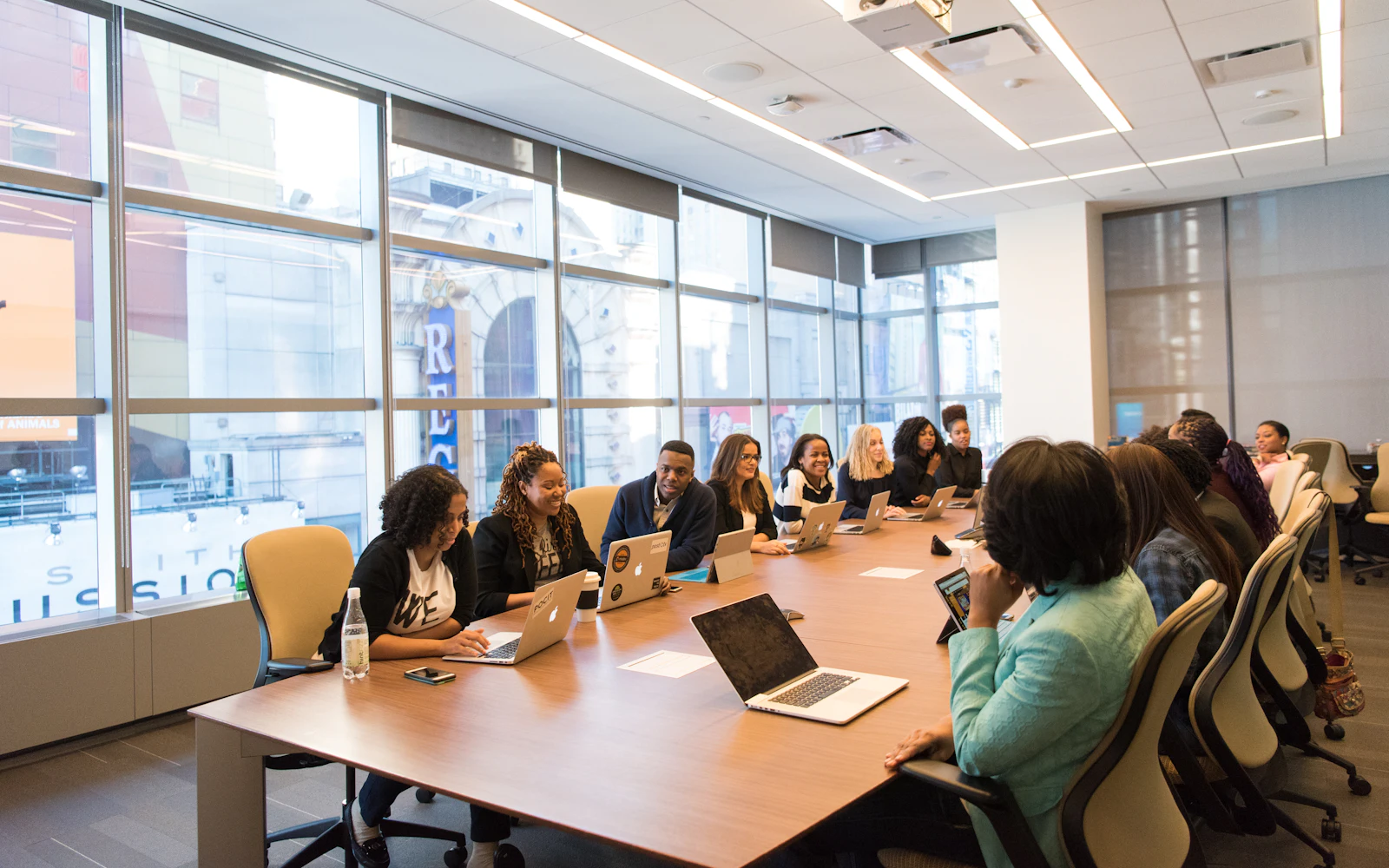 Business team meeting around a table with laptops